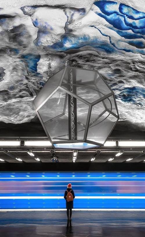 A metro station constructed of shiny rock with a polyhedral lantern